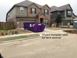 A 15-yard purple dumpster used for deck removal by Liberty Hill Dumpster Rental at a residential property in Austin, TX