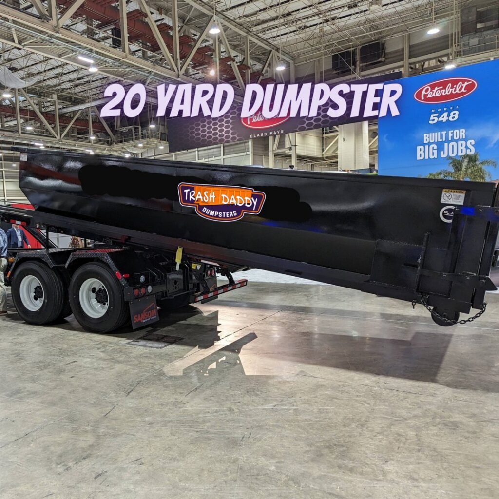 A 20-yard dumpster being loaded onto a truck for transport by Trash Daddy in Fort Worth, TX