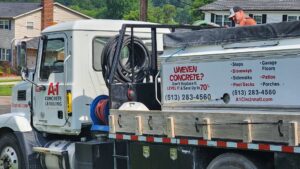 An A1 Concrete Leveling Cincinnati/NKY truck with a worker preparing for a job, showcasing their service in Cincinnati, OH.
