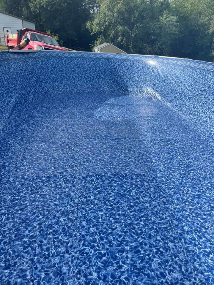 The blue liner of an above-ground pool being filled with water during installation by Advanced Pools and Repair, LLC in Bristol, CT.