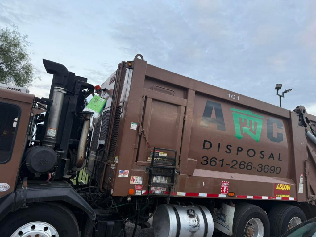A large brown AC Disposal LLC junk removal truck with branding parked in San Antonio, TX.