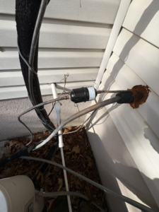 Close-up of refrigerant lines and filter on an AC unit, showing repair work by HomeFront Services LLC in Fayetteville, AR