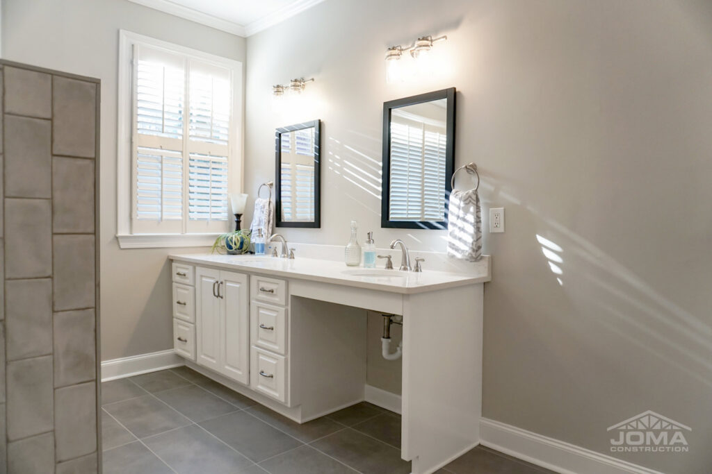 A modern bathroom featuring an accessible vanity and mirrors, installed by JOMA Construction in Athens, GA.