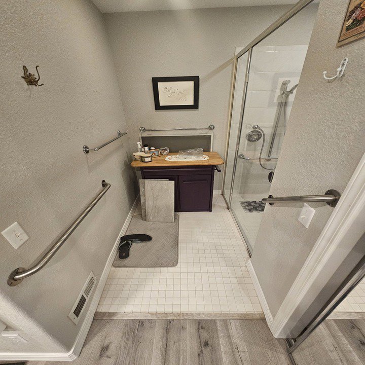 An accessible bathroom featuring a walk-in shower and grab bars, renovated by Jedi Bldrs in Colorado Springs, CO.