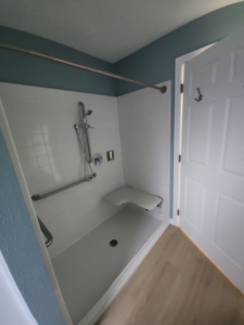 An accessible shower with a built-in seat and grab bars installed by Leupitz Contractors Inc in Salem, OR.
