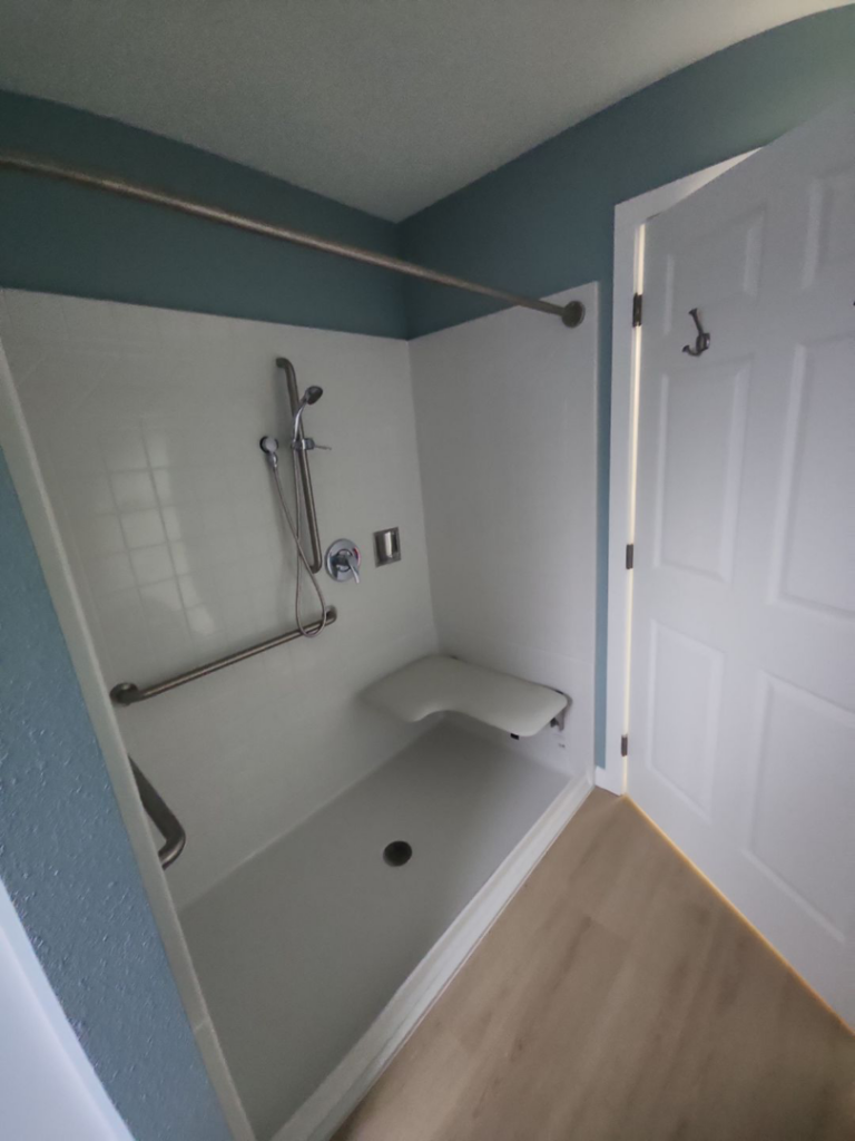 An accessible shower with a built-in seat and grab bars installed by Leupitz Contractors Inc in Salem, OR.
