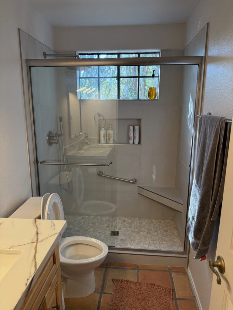 An accessible walk-in shower bathroom renovation with grab bars and a bench by AZ New Bath in Glendale, AZ