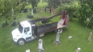 An aerial view of a grapple truck collecting tree debris in a cemetery, performed by Crockett's Tree Service in Lafayette, IN.