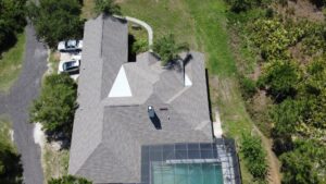 An aerial view of a residential roof showing signs of repair or replacement work by Hastings Roofing Service Inc. in Orlando, FL.