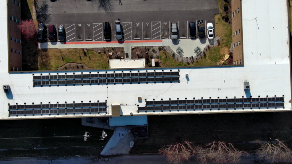 An aerial view of a completed solar panel installation on a large building by Solar by Ecos in Louisville, KY.
