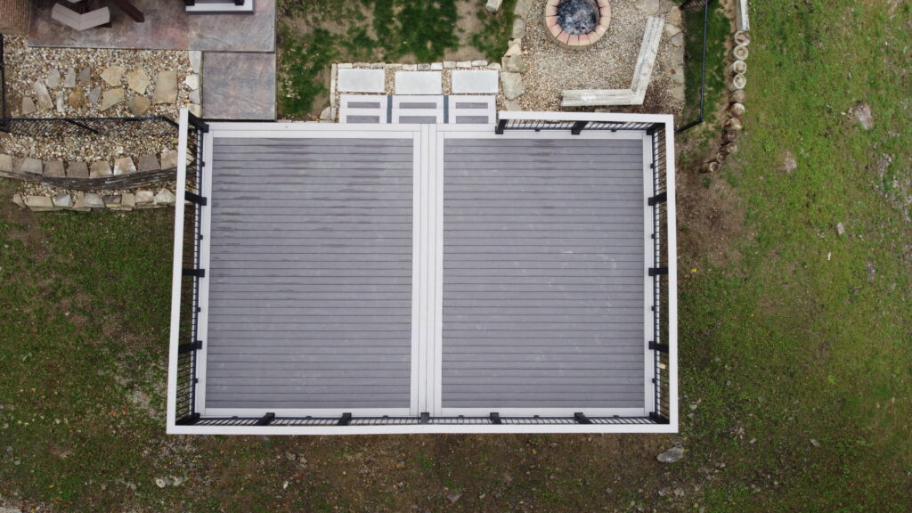 An aerial view of a new composite deck with a fire pit area, installed by McIntyre's Renovations LLC in Pittsburgh, PA