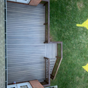 An aerial view showcasing a newly installed composite deck with brown railings and stairs, completed by Matt Hingle Construction in Bowling Green, KY.