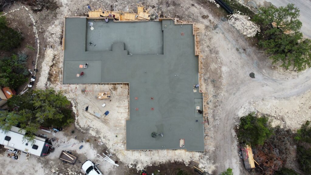 An aerial view of a large concrete foundation pour in progress by R and R contractors in Rogers, AR.