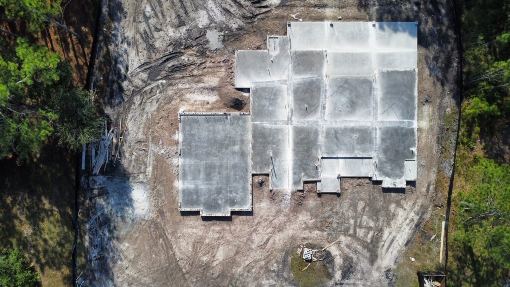 An aerial view of large concrete foundation slabs poured on a construction site by Bayside Concrete & Construction in Tampa, FL