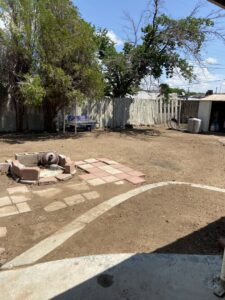An aerial view of a large fallen tree cut into sections during removal by R and J Tree Service in Farmington, NM.
