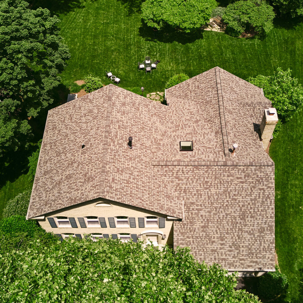 An aerial view of a house with a recently installed roof, demonstrating home improvement services by Four Seasons Home Improvement Company, Inc. in Rockville, MD.