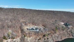 An aerial view of a house under construction on a hillside by AB Insulation in Palmyra, NY.