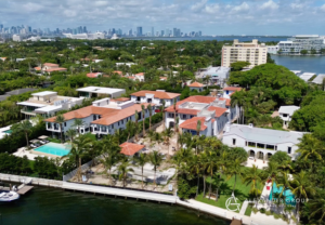 An aerial view of a luxury home construction project by Alexander Group Construction in Miami, FL, with the city skyline in the background.
