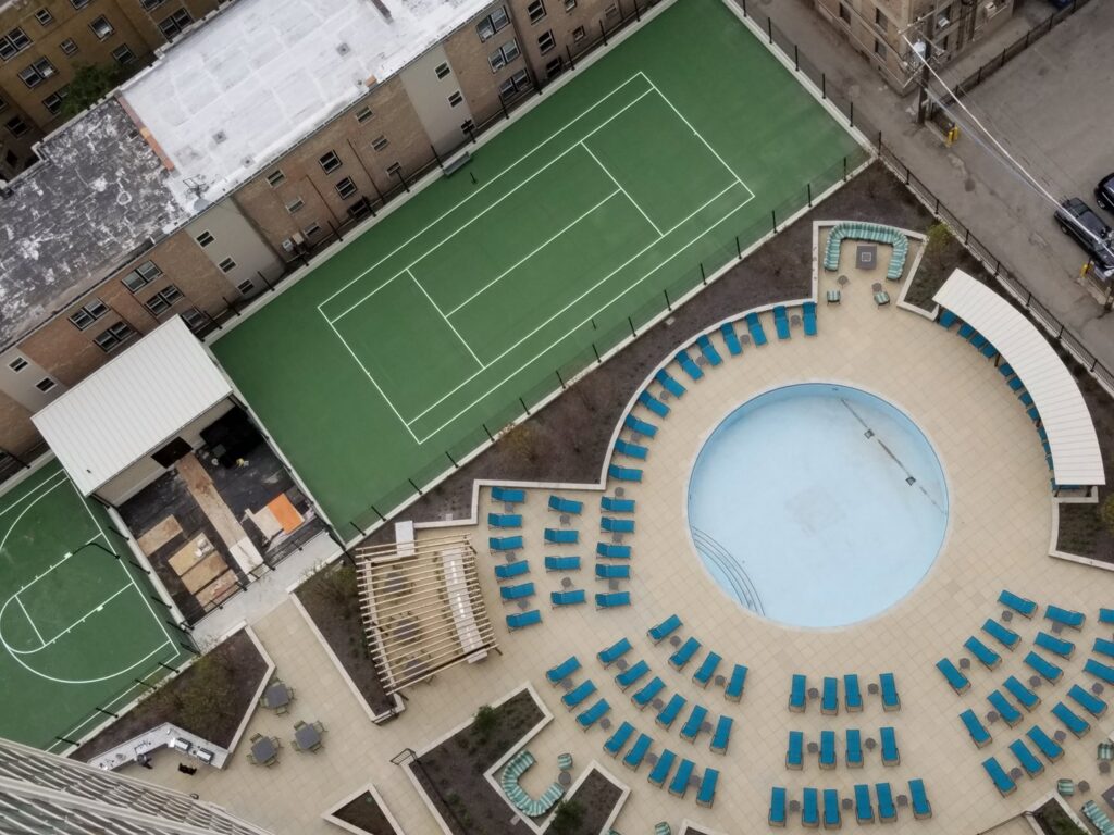 An aerial view of multi-family outdoor amenities, including a pool and sports courts, built by Specialized Building Services Inc. in Chicago, IL.