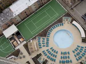 An aerial view of multi-family outdoor amenities, including a pool and sports courts, built by Specialized Building Services Inc. in Chicago, IL.