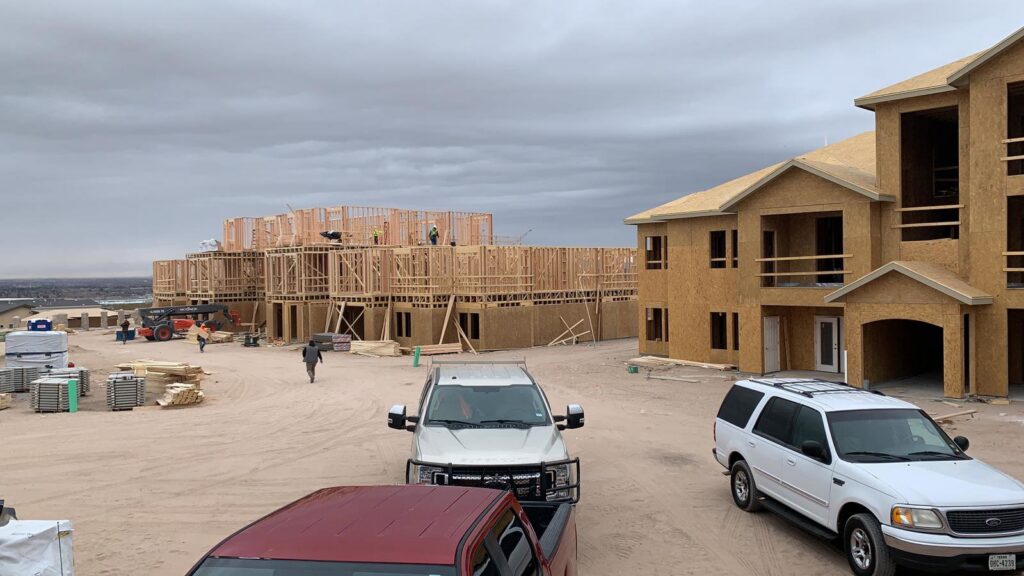 An aerial view of a residential home featuring a newly installed brown shingle roof by Masota Construction in El Paso, TX.