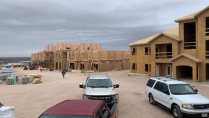 An aerial view of a residential home featuring a newly installed brown shingle roof by Masota Construction in El Paso, TX.
