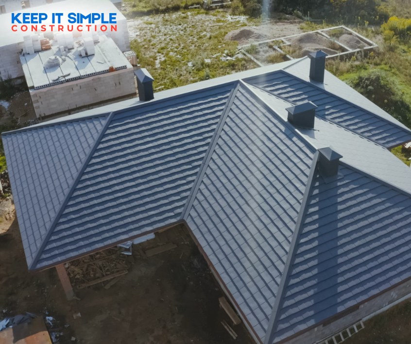 An aerial view of a house with a new dark gray roof installed by Keep It Simple Construction LLC in Woodburn, IN.