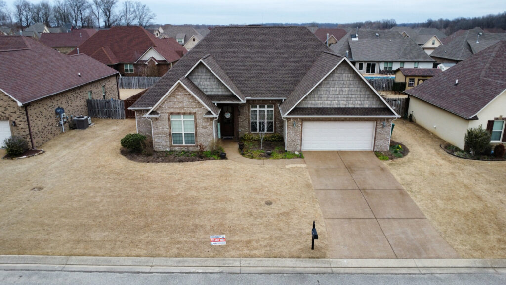 An aerial view of a residential home showcasing a newly installed roof by Northcross Restoration Inc in Memphis, TN.