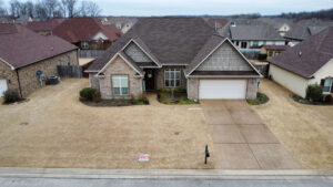 An aerial view of a residential home showcasing a newly installed roof by Northcross Restoration Inc in Memphis, TN.