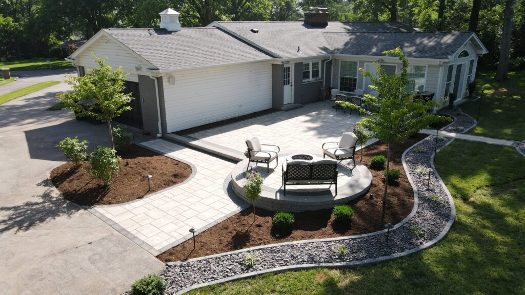 An aerial view of a custom paver patio, fire pit, and outdoor lighting installed by Rescue Landscaping and Outdoor Living in St. Louis, MO