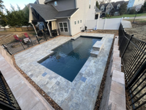 An aerial view of a newly constructed pool area with extensive patio and retaining walls by Southern Pool Solutions in Knoxville, TN.