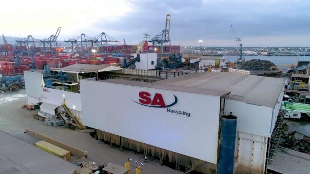 An aerial view of the SA Recycling facility with shipping containers and cranes in the background in Los Angeles, CA.