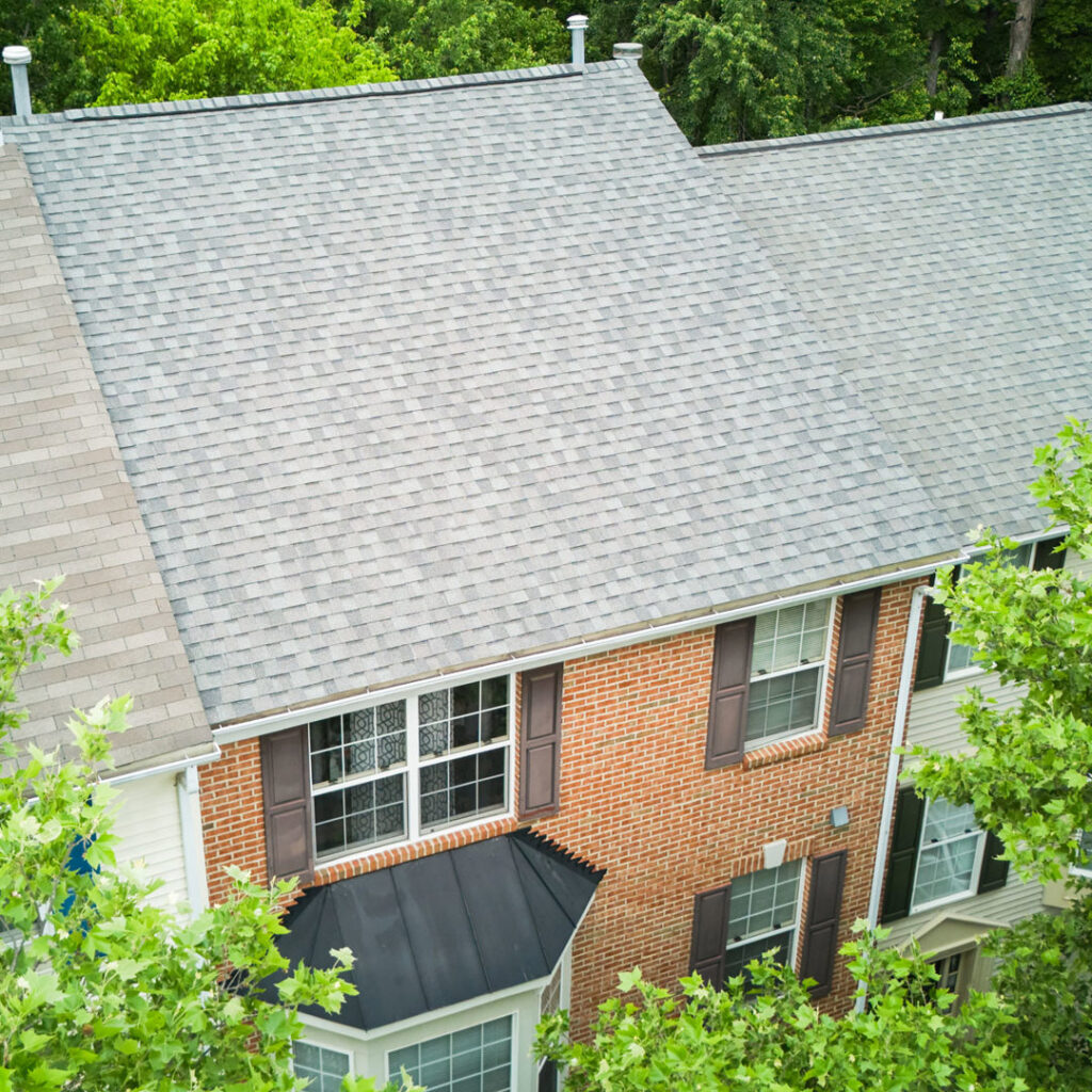 An aerial view of townhouses with recently installed roofs, demonstrating home improvement services by Four Seasons Home Improvement Company, Inc. in Rockville, MD.