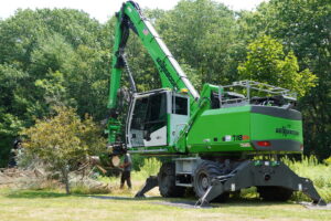 An aerial view of tree removal and chipping operations with heavy equipment by Dark Arbor Tree Care in Portland, ME.