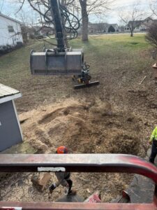 An aerial view from a bucket lift showing tree service equipment and a worker on the ground by El tree service in Columbus, OH.