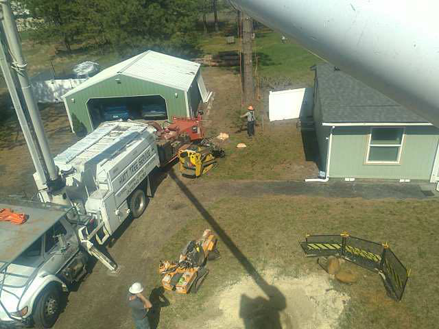 An aerial view of a tree service job site with a large truck, equipment, and workers from Hiatt Services in Spokane, WA.