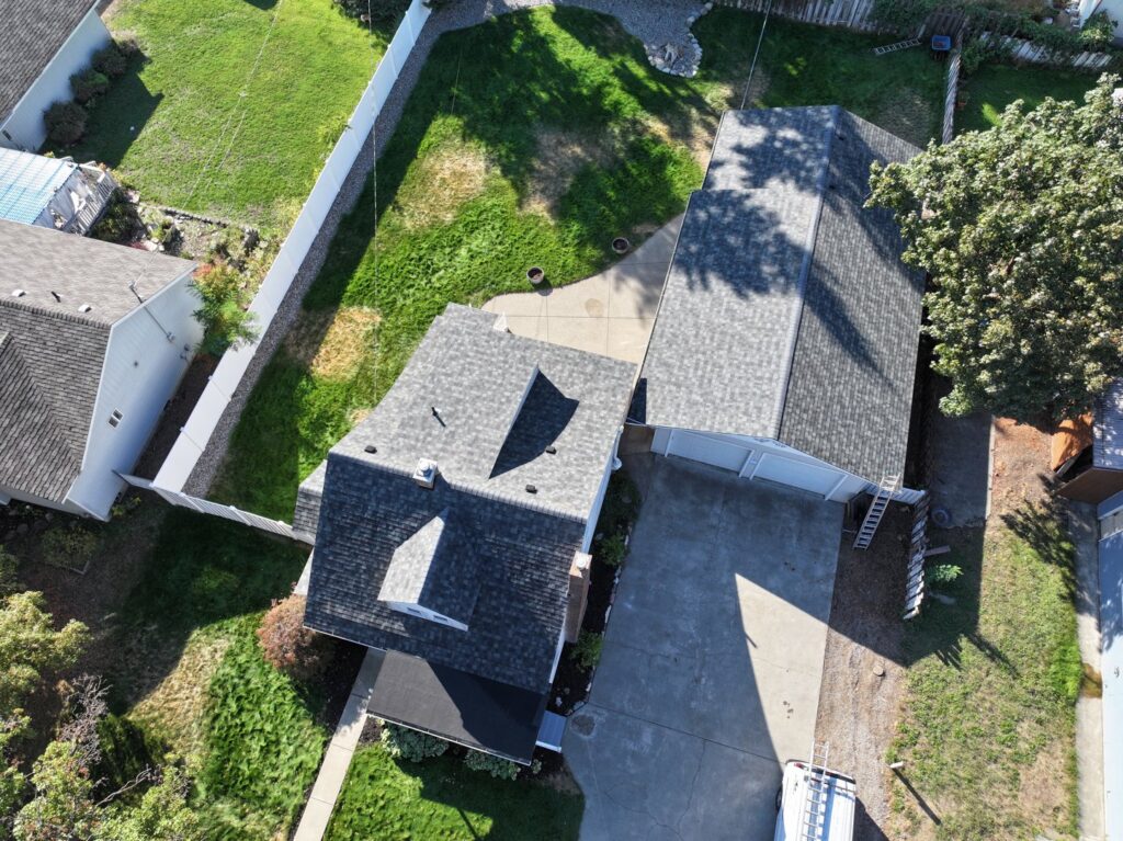 An aerial view of two residential houses with newly installed roofs by Proline Roofing in Shipshewana, IN.