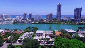 An aerial view of waterfront properties under construction with the Miami skyline in the background by Intelligent Construction Inc. in Miami, FL.