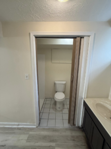 A newly remodeled basement bathroom featuring a modern toilet, vanity, and flooring by Inside Out Commercial Solutions in Cleveland, OH.