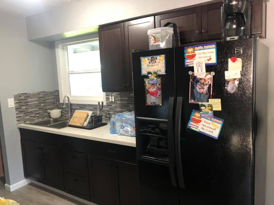 After kitchen remodel featuring new dark cabinets and mosaic backsplash by All in One Remodeling Services LLC in East Sandwich, MA