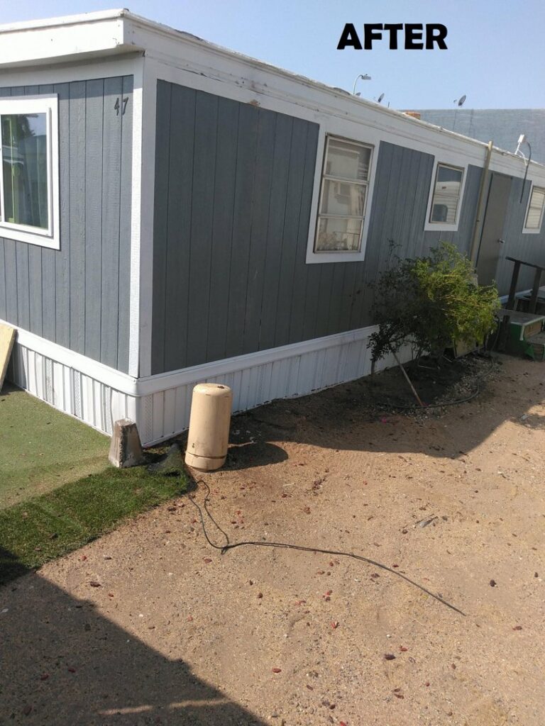 A residential area after a tall palm tree was removed by Alia's Tree Services And Landscaping in Phoenix, AZ.