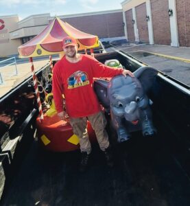 A Junk Haulin Heroes team member removing amusement rides from a truck bed in Bismarck, ND.