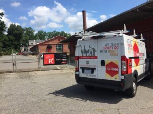 An Andrew Roby Handyman service van with ladders on the roof, parked and ready for jobs in Charlotte, NC.