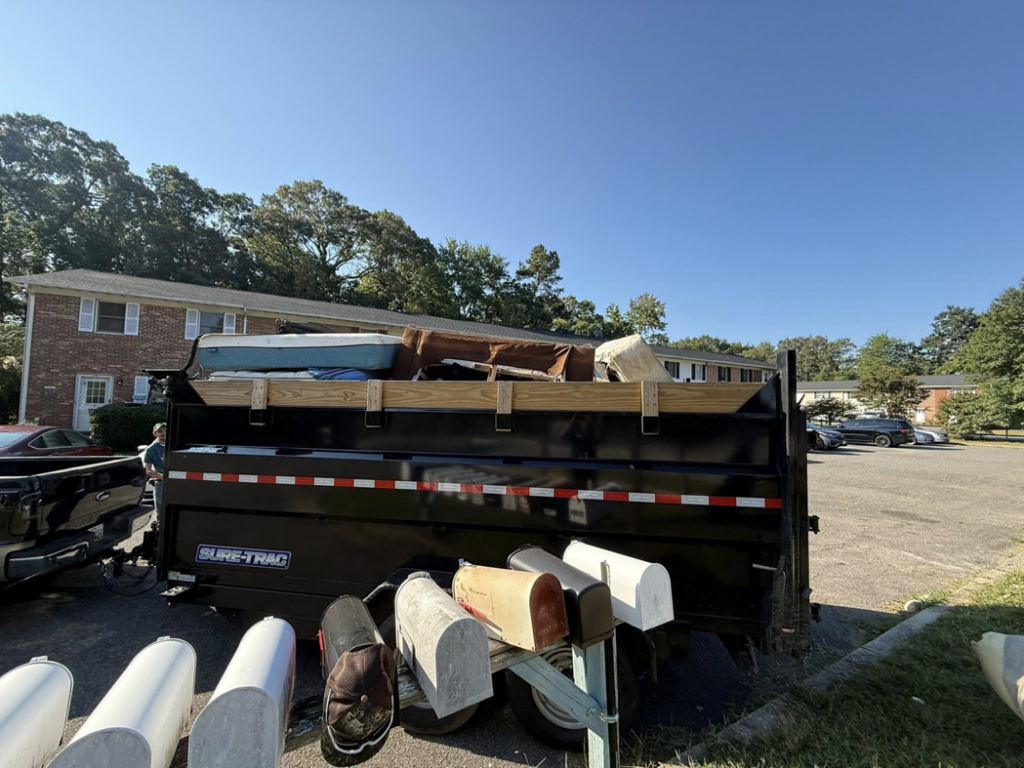 A junk removal trailer full of items parked at an apartment complex for Freedom Hauling in California, MD.