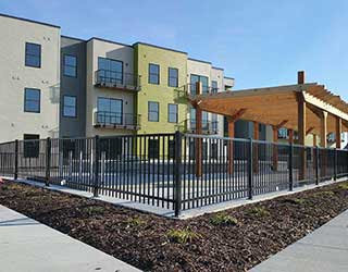 A black metal fence installed around a pool area at an apartment complex by R & C Fence in Fort Wayne, IN.