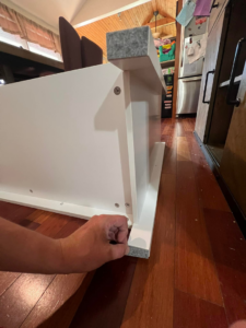 A handyman from Assembly Required carefully applying felt pads to the bottom of a newly assembled furniture leg in Summerville, SC.