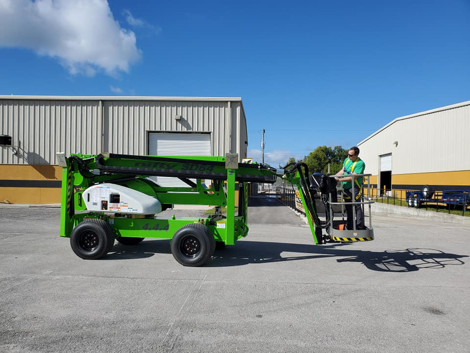 An arborist climbing and pruning a tall tree, performing tree service work for Beaver Tree Service in Des Moines, IA