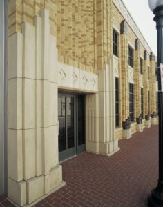 An Art Deco style building entrance with prominent cast stone architectural details by Dallas Cast Stone in Dallas, TX