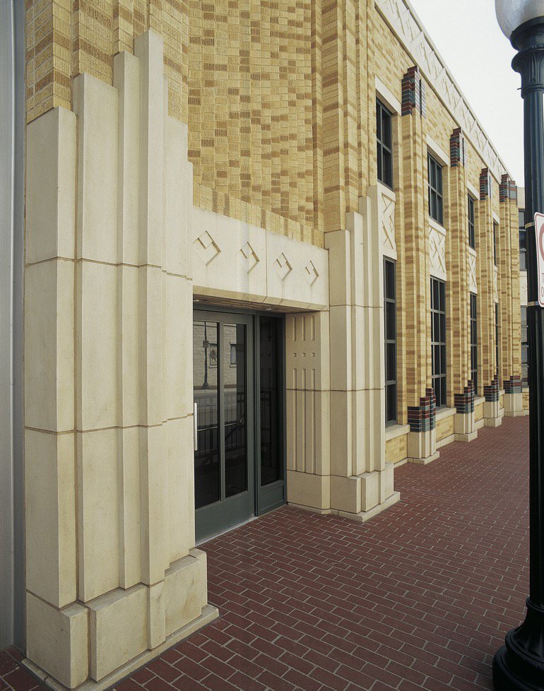 An Art Deco style building entrance with prominent cast stone architectural details by Dallas Cast Stone in Dallas, TX