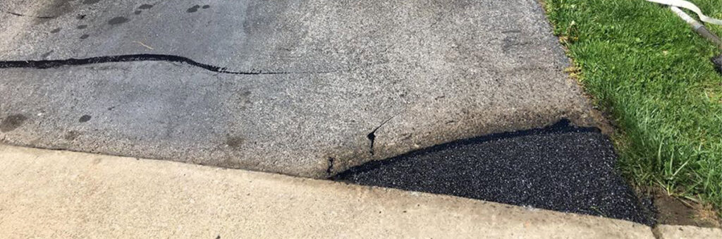 Cracked asphalt driveway repair work by Angeles Contractors LLC in New Oxford, PA.